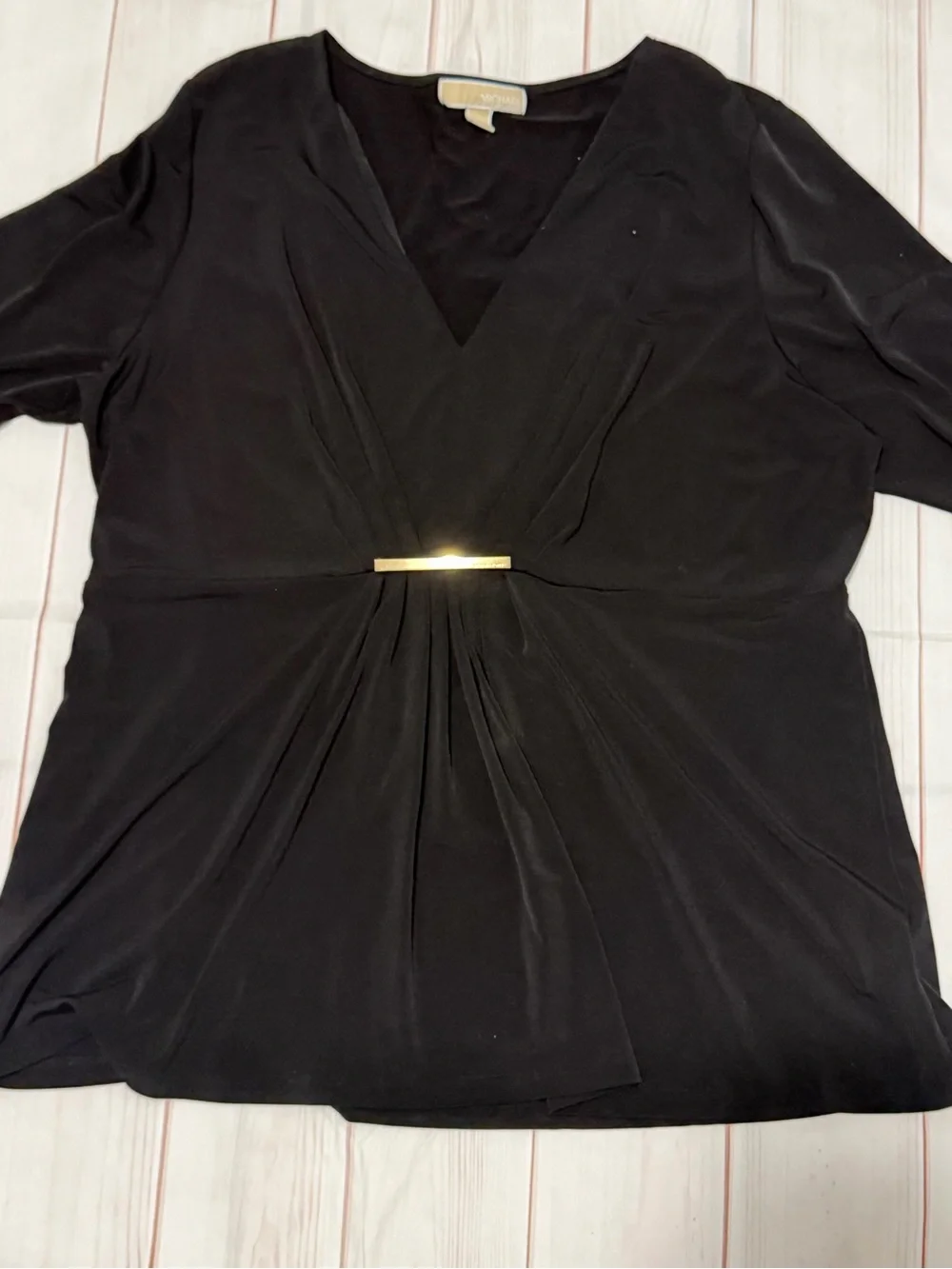 Black Michael Kors blouse with a V-neck, faux-wrap design, and gold bar at the w